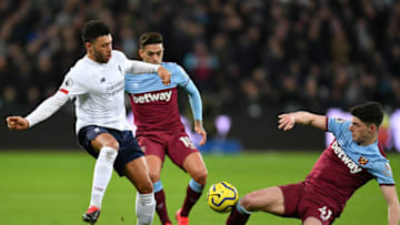 LONDON, ENGLAND - JANUARY 29: Alex Oxlade-Chamberlain of Liverpool is tackled by Declan Rice of West Ham United during the Premier League match between West Ham United and Liverpool FC at London Stadium on January 29, 2020 in London, United Kingdom. (Photo by Justin Setterfield/Getty Images)
