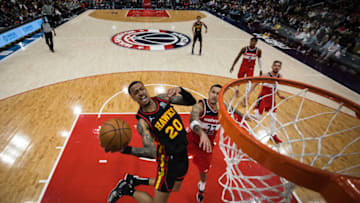 WASHINGTON, DC - MARCH 04: John Collins #20 of the Atlanta Hawks goes to the basket against Kyle Kuzma #33 of the Washington Wizards during the second half at Capital One Arena on March 4, 2022 in Washington, DC. NOTE TO USER: User expressly acknowledges and agrees that, by downloading and or using this photograph, User is consenting to the terms and conditions of the Getty Images License Agreement. (Photo by Scott Taetsch/Getty Images)