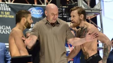 Jul 10, 2015; Las Vegas, NV, USA; UFC president Dana White (center) separates Conor McGregor (right) and Chad Mendes (left) during weigh-ins for UFC 189 at MGM Grand Garden Arena. Mandatory Credit: Joe Camporeale-USA TODAY Sports