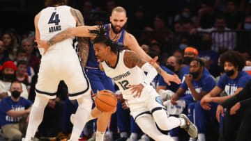 NEW YORK, NY - FEBRUARY 02: Ja Morant #12 of the Memphis Grizzlies drives around Evan Fournier #13 of the New York Knicks during the first quarter on February 2, 2022 at Madison Square Garden in New York City. NOTE TO USER: User expressly acknowledges and agrees that, by downloading and or using this photograph, User is consenting to the terms and conditions of the Getty Images License Agreement. (Photo by Rich Graessle/Getty Images)