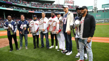 BOSTON, MASSACHUSETTS - APRIL 09: (L-R) Matthew Slater, Joe Cardona, Manny Ramirez, Mike Lowell, David Ortiz, Steve Pearce, Rob Gronkowski, Duron Harmon, and Patrick Chung pose for photos with World Series trophies and Vince Lombardi trophies before the home opener between the Toronto Blue Jays and the Boston Red Sox at Fenway Park on April 09, 2019 in Boston, Massachusetts. (Photo by Maddie Meyer/Getty Images)