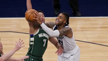 Milwaukee Bucks guard Bryn Forbes fouls Minnesota Timberwolves guard D'Angelo Russell. Mandatory Credit: Brad Rempel-USA TODAY Sports