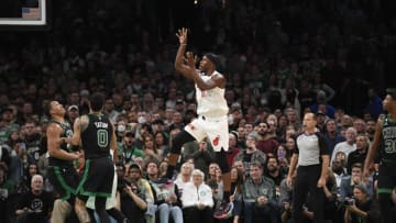 Miami Heat forward Jimmy Butler (22) shoots the ball while Boston Celtics forward Grant Williams (12) and forward Jayson Tatum (0) look on(Bob DeChiara-USA TODAY Sports)