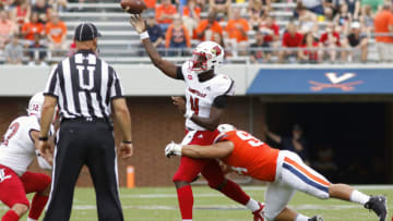 CHARLOTTESVILLE, VA - SEPTEMBER 22: Aaron Faumui #94 of the Virginia Cavaliers hits Jawon Pass #4 of the Louisville Cardinals as he throws an interception in the second half during a game at Scott Stadium on September 22, 2018 in Charlottesville, Virginia. (Photo by Ryan M. Kelly/Getty Images)
