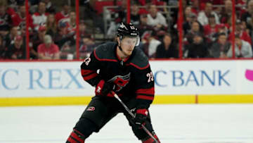 RALEIGH, NC - MAY 16: Brock McGinn #23 of the Carolina Hurricanes controls the puck on the ice in Game Four of the Eastern Conference Third Round against the Boston Bruins during the 2019 NHL Stanley Cup Playoffs on May 16, 2019 at PNC Arena in Raleigh, North Carolina. (Photo by Gregg Forwerck/NHLI via Getty Images)