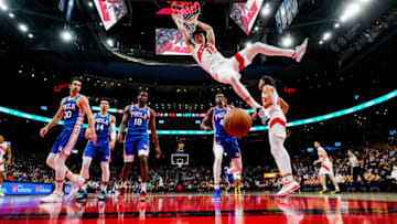 TORONTO, ON - OCTOBER 04: Yuta Watanabe #18 of the Toronto Raptors hangs on the rim for a slam dunk against the Philadelphia 76ers during preseason action at Scotiabank Arena on October 4, 2021 in Toronto, Canada. NOTE TO USER: User expressly acknowledges and agrees that, by downloading and or using this photograph, User is consenting to the terms and conditions of the Getty Images Agreement. (Photo by Mark Blinch/Getty Images)