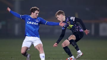 SOUTHPORT, ENGLAND - JANUARY 24: Harvey White of Tottenham Hotspur is challenged by Lewis Warrington of Everton during the Premier League 2 match between Everton U23 and Tottenham Hotspur U23 at Pure Stadium on January 24, 2022 in Southport, England. (Photo by Lewis Storey/Getty Images)