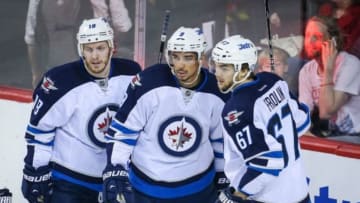 Apr 11, 2014; Calgary, Alberta, CAN; Winnipeg Jets left wing Evander Kane (9) celebrates his goal with teammates against the Calgary Flames during the first period at Scotiabank Saddledome. Mandatory Credit: Sergei Belski-USA TODAY Sports