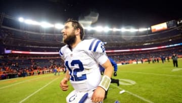 Jan 11, 2015; Denver, CO, USA; Indianapolis Colts quarterback Andrew Luck (12) runs off the field after beating the Denver Broncos in the 2014 AFC Divisional playoff football game at Sports Authority Field at Mile High. The Colts won 24-13. Mandatory Credit: Ron Chenoy-USA TODAY Sports