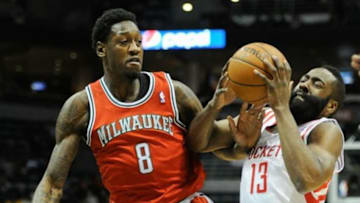 Feb 8, 2014; Milwaukee, WI, USA; Houston Rockets guard James Harden (13) drives for the basket against Milwaukee Bucks center Larry Sanders (8) in the first quarter at BMO Harris Bradley Center. Mandatory Credit: Benny Sieu-USA TODAY Sports