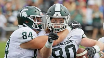 EVANSTON, ILLINOIS - SEPTEMBER 21: Matt Seybert #80 and Noah Davis #84 of the Michigan State Spartans celebrate after Seybert caught a touchdown pass against the Northwestern Wildcats at Ryan Field on September 21, 2019 in Evanston, Illinois. Michigan State defeated Northwestern 31-10. (Photo by Jonathan Daniel/Getty Images)