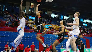 Feb 20, 2021; Lawrence, Kansas, USA; Texas Tech Red Raiders guard Kevin McCullar (15) shoots against Kansas Jayhawks guard Marcus Garrett (0) during the second half at Allen Fieldhouse. Mandatory Credit: Jay Biggerstaff-USA TODAY Sports