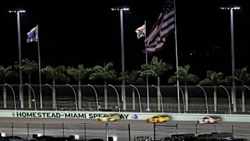 Nov 22, 2015; Homestead, FL, USA; Sprint Cup Series driver Kyle Busch (18), Sprint Cup Series driver Joey Logano (22) and Sprint Cup Series driver Kevin Harvick (4) race down the back stretch during the Ford EcoBoost 400 at Homestead-Miami Speedway. Mandatory Credit: Peter Casey-USA TODAY Sports
