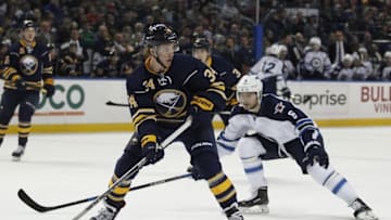 Mar 26, 2016; Buffalo, NY, USA; Buffalo Sabres defenseman Casey Nelson (34) looks to make a pass while being defended by Winnipeg Jets center Alexander Burmistrov (6) during the first period at First Niagara Center. Mandatory Credit: Timothy T. Ludwig-USA TODAY Sports