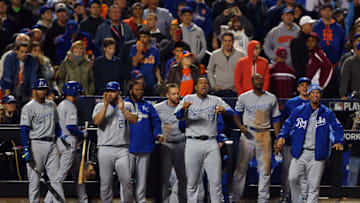 NEW YORK, NY - NOVEMBER 01: Kansas City Royals players react after Jarrod Dyson #1 of the Kansas City Royals (not pictured) scores the go-ahead run in the twelfth inning against the New York Mets during Game Five of the 2015 World Series at Citi Field on November 1, 2015 in the Flushing neighborhood of the Queens borough of New York City. (Photo by Elsa/Getty Images)