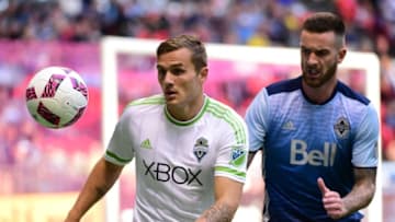 Oct 2, 2016; Vancouver, British Columbia, CAN; Seattle Sounders forward Jordan Morris (13) battles for the ball against Vancouver Whitecaps defender David Edgar (18) during the first half at BC Place. Mandatory Credit: Anne-Marie Sorvin-USA TODAY Sports
