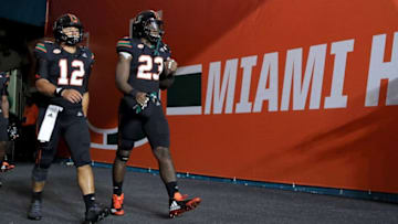 MIAMI GARDENS, FL - NOVEMBER 04: Malik Rosier #12 and Christopher Herndon IV #23 of the Miami Hurricanes takes the field during a game against the Virginia Tech Hokies at Hard Rock Stadium on November 4, 2017 in Miami Gardens, Florida. (Photo by Mike Ehrmann/Getty Images)