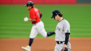 Sep 29, 2020; Cleveland, Ohio, USA; New York Yankees starting pitcher Gerrit Cole (right) reacts as Cleveland Indians left fielder Josh Naylor (31) rounds the bases after hitting a solo home run in the fourth inning at Progressive Field. Mandatory Credit: David Richard-USA TODAY Sports