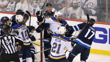 WINNIPEG, MANITOBA - APRIL 10: Adam Lowry #17 of the Winnipeg Jets grabs Pat Maroon #7 of the St. Louis Blues in Game One of the Western Conference First Round during the 2019 NHL Stanley Cup Playoffs at Bell MTS Place on April 10, 2019 in Winnipeg, Manitoba, Canada. (Photo by Jason Halstead/Getty Images)