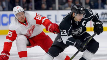 Jan 11, 2016; Los Angeles, CA, USA; Los Angeles Kings right wing Dustin Brown (23) and Detroit Red Wings defenseman Danny DeKeyser (65) battle on the ice in the third period of the game at Staples Center. Mandatory Credit: Jayne Kamin-Oncea-USA TODAY Sports