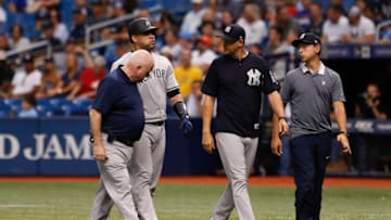 ST. PETERSBURG, FL - JUNE 24: New York Yankees catcher Gary Sanchez (24) walks off the field with New York Yankees manager Aaron Boone (17), Trainer Steve Donohue and Yankees Spanish translator Marlon Abreu after an injury in the 10th inning of the regular season MLB game between the New York Yankees and Tampa Bay Rays on June 24, 2018 at Tropicana Field in St. Petersburg, FL. (Photo by Mark LoMoglio/Icon Sportswire via Getty Images)