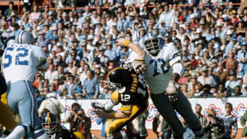 MIAMI - JANUARY 21: Ed 'Too Tall' Jones of the Dallas Cowboys tackles Terry Bradshaw of the Pittsburgh Steelers during Super Bowl XIII at the Orange Bowl on January 21, 1979 in Miami, Florida. The Steelers defeated the Cowboys 35-31. (Photo by Focus On Sport/Getty Images)