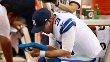 Aug 28, 2014; Arlington, TX, USA; Dallas Cowboys quarterback Brandon Weeden (3) looks at a Microsoft Surface tablet on the bench against the Denver Broncos at AT&T Stadium. Denver beat Dallas 27-3. Mandatory Credit: Tim Heitman-USA TODAY Sports