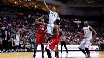Jan 22, 2015; Coral Gables, FL, USA; Miami Hurricanes guard Sheldon McClellan (10) drives to the basket between North Carolina State Wolfpack guard Ralston Turner (22) and guard Anthony Barber (12) in the second half at BankUnited Center. The Hurricanes won 65-60. Mandatory Credit: Robert Mayer-USA TODAY Sports