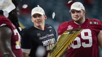 Jan 11, 2021; Miami Gardens, Florida, USA; Alabama Crimson Tide quarterback Mac Jones (10) celebrates with the trophy after defeating the Ohio State Buckeyes in the 2021 College Football Playoff National Championship Game. Mandatory Credit: Mark J. Rebilas-USA TODAY Sports