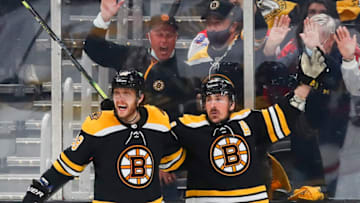 BOSTON, MA - MAY 21: Brad Marchand #63 of the Boston Bruins reacts after teamamate David Pastrnak #88 scored in the second period of Game Four of the First Round of the 2021 Stanley Cup Playoffs against the Washington Capitals at TD Garden on May 21, 2021 in Boston, Massachusetts. (Photo by Adam Glanzman/Getty Images)