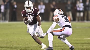 Nov 5, 2022; Starkville, Mississippi, USA;Mississippi State Bulldogs running back Jo'quavious Marks (7) runs the ball while defended by Auburn Tigers cornerback Jaylin Simpson (36) during the fourth quarter at Davis Wade Stadium at Scott Field. Mandatory Credit: Matt Bush-USA TODAY Sports