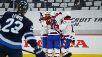 WINNIPEG, MB - JUNE 2: Brendan Gallagher #11 of the Montreal Canadiens celebrates his third period goal with teammates on Connor Hellebuyck #37 of the Winnipeg Jets in Game One of the Second Round of the 2021 Stanley Cup Playoffs on June 2, 2021 at Bell MTS Place in Winnipeg, Manitoba, Canada. (Photo by David Lipnowski/Getty Images)