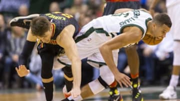 Jan 15, 2016; Milwaukee, WI, USA; Atlanta Hawks guard Kyle Korver (26) and Milwaukee Bucks guard Michael Carter-Williams (5) tangle while chasing a loose ball during the second quarter at BMO Harris Bradley Center. Mandatory Credit: Jeff Hanisch-USA TODAY Sports