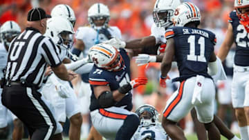 Auburn football offensive lineman Brandon Council (71) gets in a shoving match after shoving Penn State Nittany Lions defensive back Johnny Dixon (3) to the ground as Auburn Tigers take on Penn State Nittany Lions at Jordan-Hare Stadium in Auburn, Ala., on Saturday, Sept. 17, 2022. Penn State Nittany Lions leads Auburn Tigers 14-6 at halftime.