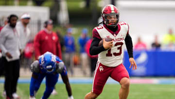 Oct 23, 2021; Lawrence, Kansas, USA; Oklahoma Sooners quarterback Caleb Williams (13) runs against the Kansas Jayhawks during the first half at David Booth Kansas Memorial Stadium. Mandatory Credit: Jay Biggerstaff-USA TODAY Sports