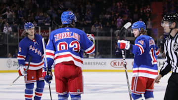 NEW YORK, NEW YORK - SEPTEMBER 18: Artemi Panarin #10 (R) of the New York Rangers celebrates his second period goal against the New Jersey Devils and is joined by Jacob Trouba #8 (L) and Mika Zibanejad #93 (C) at Madison Square Garden on September 18, 2019 in New York City. (Photo by Bruce Bennett/Getty Images)