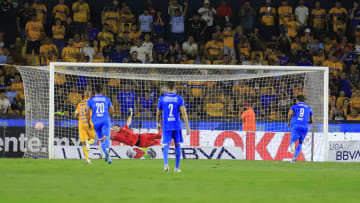 Santiago Giménez (right) watches as his penalty kick zips into the left side of the net, giving Cruz Azul a 3-2 win over the Tigres in their Liga MX season opener. (Photo by Jaime Lopez/Jam Media/Getty Images)