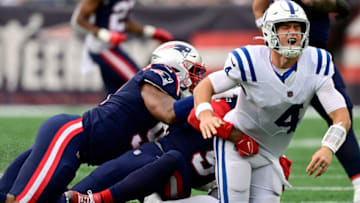 FOXBOROUGH, MASSACHUSETTS - NOVEMBER 06: Sam Ehlinger #4 of the Indianapolis Colts gets tackled by Matthew Judon #9 of the New England Patriots in the second quarter at Gillette Stadium on November 06, 2022 in Foxborough, Massachusetts. (Photo by Billie Weiss/Getty Images)