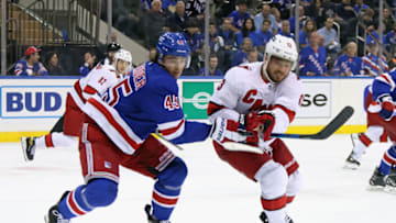 NEW YORK, NEW YORK - MAY 28: Braden Schneider #45 of the New York Rangers checks Max Domi #13 of the Carolina Hurricanes in Game Six of the Second Round of the 2022 Stanley Cup Playoffs at Madison Square Garden on May 28, 2022 in New York City. The Rangers defeated the Hurricanes 5-2. (Photo by Bruce Bennett/Getty Images)