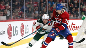 Dec 22, 2016; Montreal, Quebec, CAN; Montreal Canadiens defenseman Nathan Beaulieu (28) and Minnesota Wild center Mikael Granlund (64) battle for the puck during the first period at Bell Centre. Mandatory Credit: Jean-Yves Ahern-USA TODAY Sports