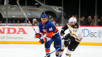 NEW YORK, NY - MARCH 25: David Backes #42 of the Boston Bruins reaches for the puck against Joshua Ho-Sang #66 of the New York Islanders during the third period at the Barclays Center on March 25, 2017 in Brooklyn borough of New York City. The Bruins defeated the Islanders 2-1. (Photo by Paul Bereswill/NHLI via Getty Images)