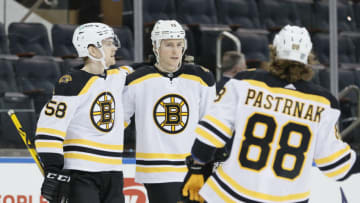 NEW YORK, NEW YORK - FEBRUARY 28: David Pastrnak #88, Charlie Coyle #13, and Urho Vaakanainen #58 of the Boston Bruins celebrate Coyle's goal during the first period against the New York Rangers at Madison Square Garden on February 28, 2021 in New York City. (Photo by Sarah Stier/Getty Images)