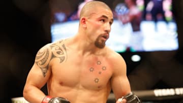 Robert Whittaker of Australia in action against Israel Adesanya of New Zealand during the middleweight title bout of the UFC 243 fight night in Melbourne on October 6, 2019. (Photo by ASANKA BRENDON RATNAYAKE / AFP) / -- IMAGE RESTRICTED TO EDITORIAL USE - STRICTLY NO COMMERCIAL USE -- (Photo by ASANKA BRENDON RATNAYAKE/AFP via Getty Images)