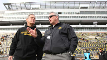 IOWA CITY, IA - OCTOBER 26: Head coach Kirk Ferentz of the Iowa Hawkeyes visits with athletic director Gary Barta prior to the match-up against the Northwestern Wildcats on October 26, 2013 at Kinnick Stadium in Iowa City, Iowa. (Photo by Matthew Holst/Getty Images)