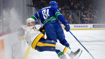 VANCOUVER, CANADA - MARCH 6: Tyson Barrie #22 of the Nashville Predators is checked by Dakota Joshua #81 of the Vancouver Canucks during the third period of their NHL game at Rogers Arena on March 6, 2023 in Vancouver, British Columbia, Canada. (Photo by Derek Cain/Getty Images)