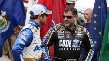 Aug 3, 2014; Long Pond, PA, USA; NASCAR Sprint Cup Series drivers Jimmie Johnson (L) and driver Tony Stewart (14) talk prior to the GoBowling.com 400 at Pocono Raceway. Mandatory Credit: Bill Streicher-USA TODAY Sports