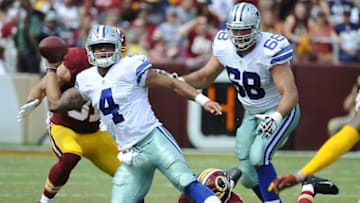 Sep 18, 2016; Landover, MD, USA; Dallas Cowboys quarterback Dak Prescott (4) is pressured by Washington Redskins outside linebacker Preston Smith (94) during the first half at FedEx Field. Mandatory Credit: Brad Mills-USA TODAY Sports