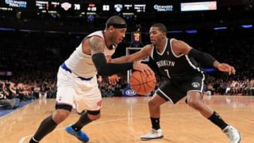 Jan. 21, 2013; New York, NY, USA; New York Knicks small forward Carmelo Anthony (7) drives the ball around Brooklyn Nets shooting guard Joe Johnson (7) during the second half at Madison Square Garden. Nets won 88-85. Mandatory Credit: Debby Wong-USA TODAY Sports