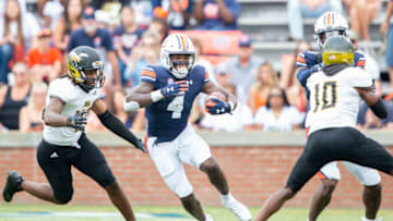 AUBURN, ALABAMA - SEPTEMBER 11: Running back Tank Bigsby #4 of the Auburn Tigers runs the ball by linebacker Dylan Creech #40 of the Alabama State Hornets during the first quarter of play at Jordan-Hare Stadium on September 11, 2021 in Auburn, Alabama. (Photo by Michael Chang/Getty Images)