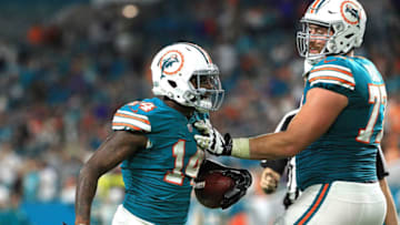 MIAMI GARDENS, FL - DECEMBER 31: Jarvis Landry being held back by temmate Jesse Davis